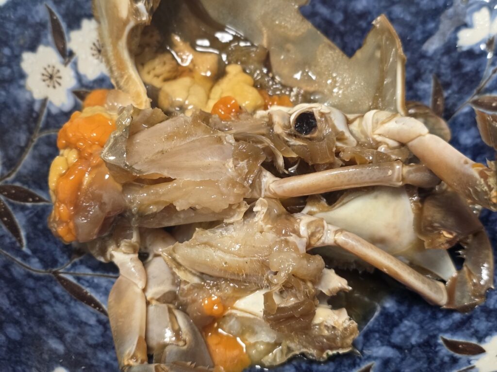 5 Umami Secrets of Ganjang-gejang featuring a close-up of golden crab roe on white rice