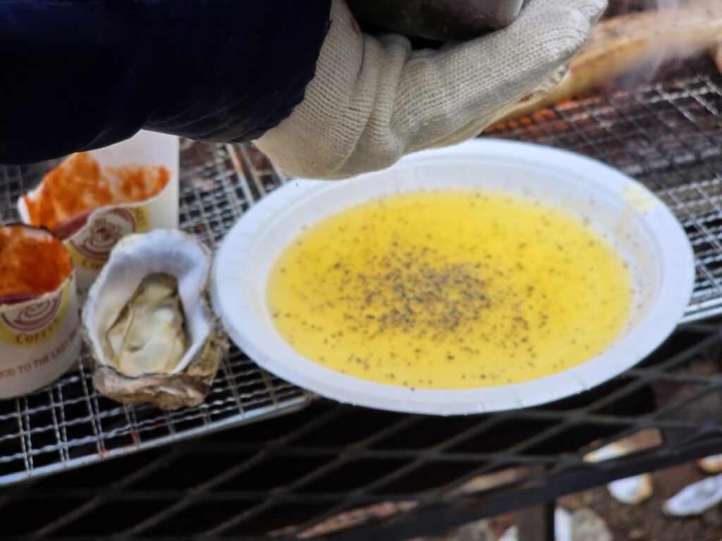 A close-up view of golden Authentic Perilla Oil Sauce seasoned with a generous amount of coarse black pepper.