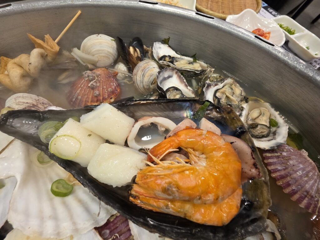 3 Best Korean Steamed Seafood Rituals for Healthier Living featuring a variety of fresh shellfish, shrimp, and fish cakes.