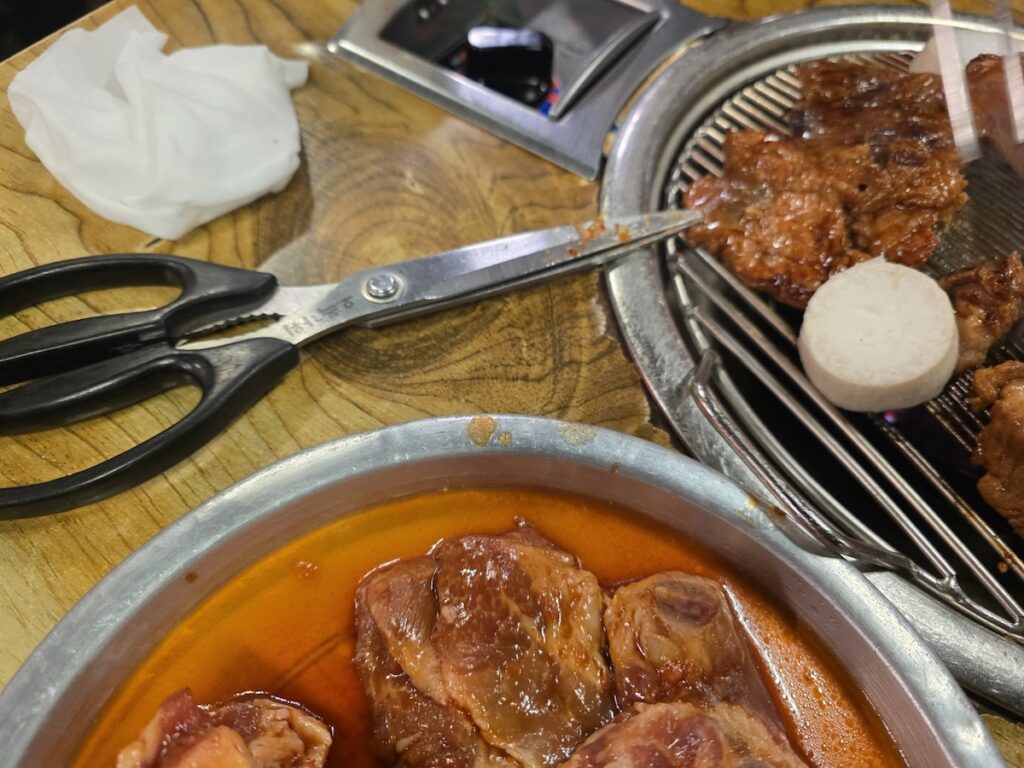 Marinated pork ribs grilling on a Korean barbecue charcoal grill