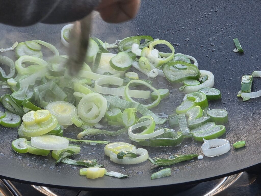 Infusing green onion oil with ramen noodles and spicy seasoning for the best Korean spicy ramen recipe.