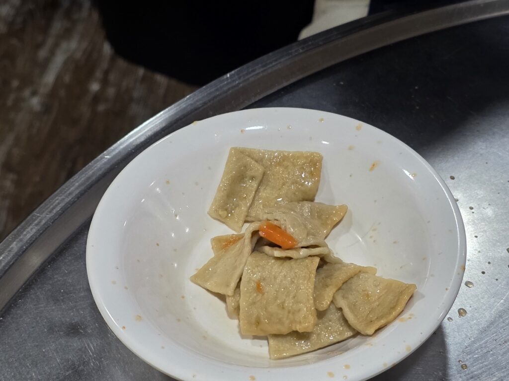 Savory stir-fried fish cakes served as a complimentary side dish in the daily **Gangnam Lunch Ritual**.