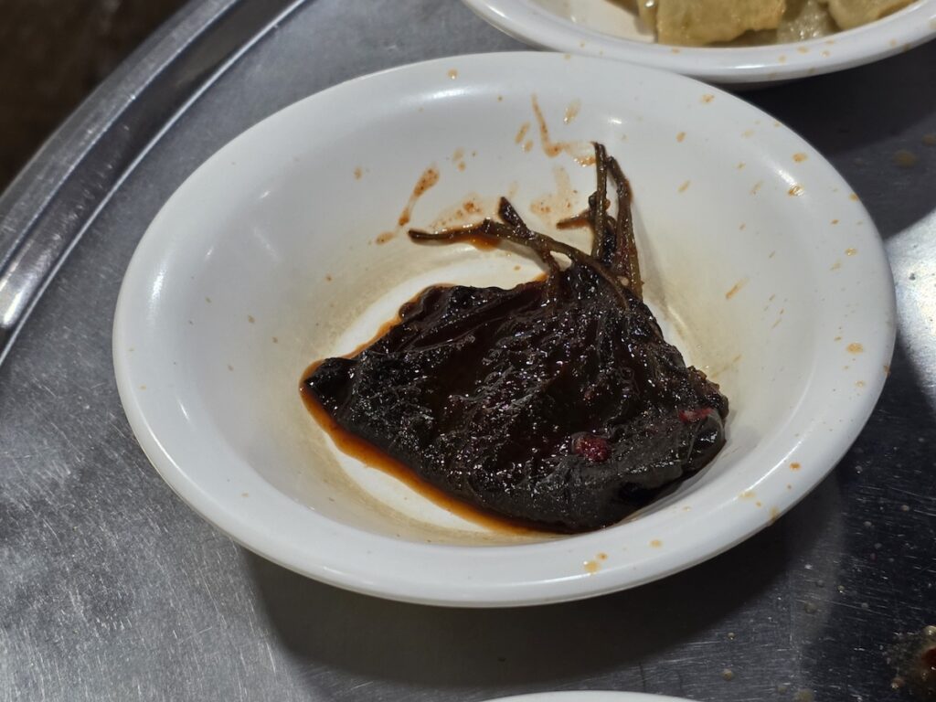 Traditional marinated perilla leaves, the famous "rice thief" and a cultural staple of the **Gangnam Lunch Ritual**.