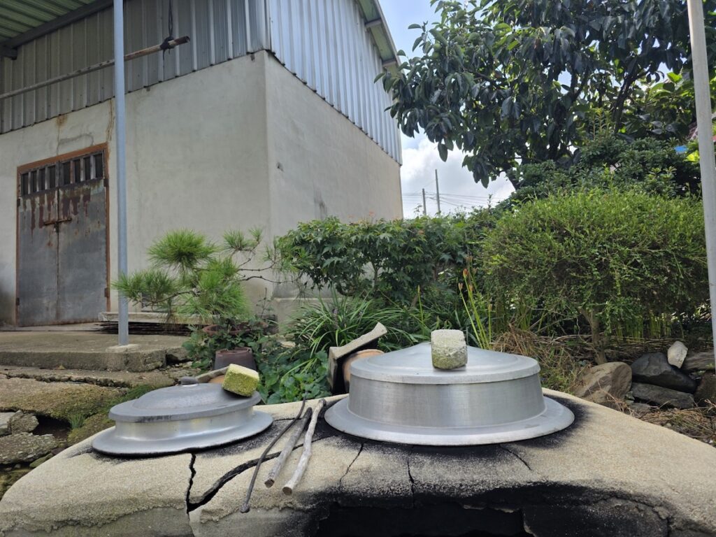 A cinematic wide shot of a traditional Gamasot iron pot on a rural hearth, representing the authentic Korea Travel 2026 firewood cooking ritual.
