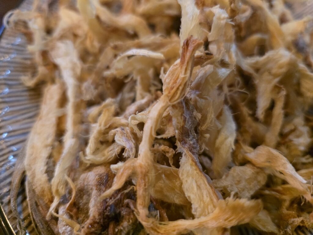 A close-up of the crispy texture of Meoktae, highlighting the culinary appeal of **Korean 2-cha Culture 2026**.