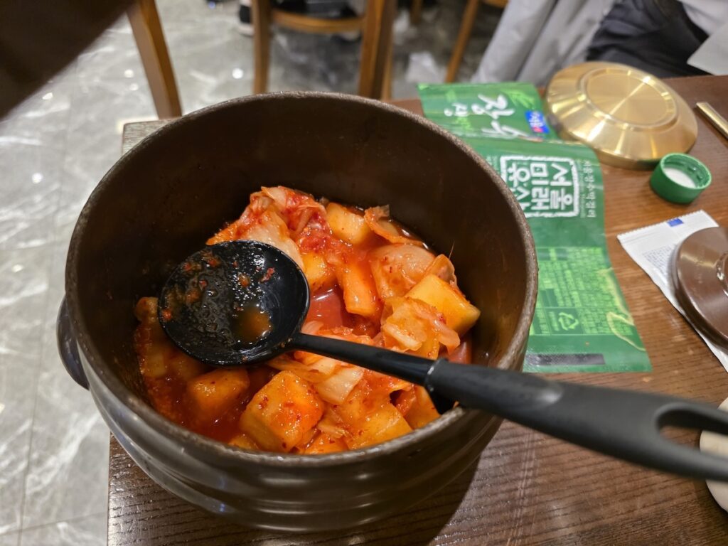 A traditional earthenware pot filled with Kkakdugi (cubed radish kimchi), an essential side dish for the Authentic Korean Hangover Soup Guide.
