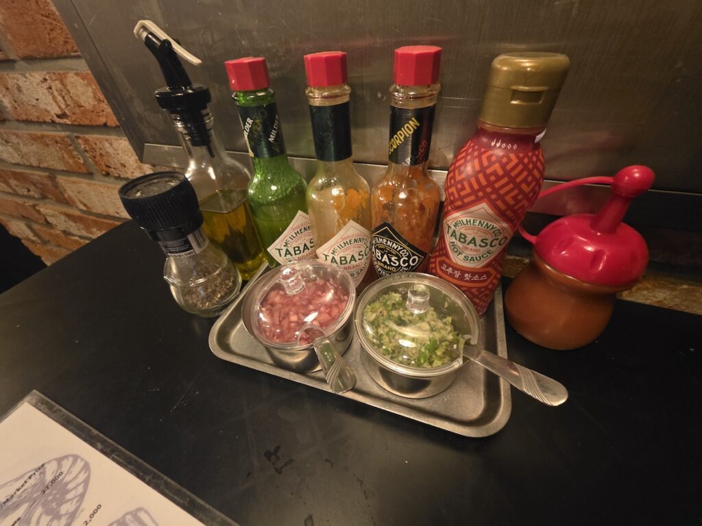 Different sauces and condiments served with oysters in Korea