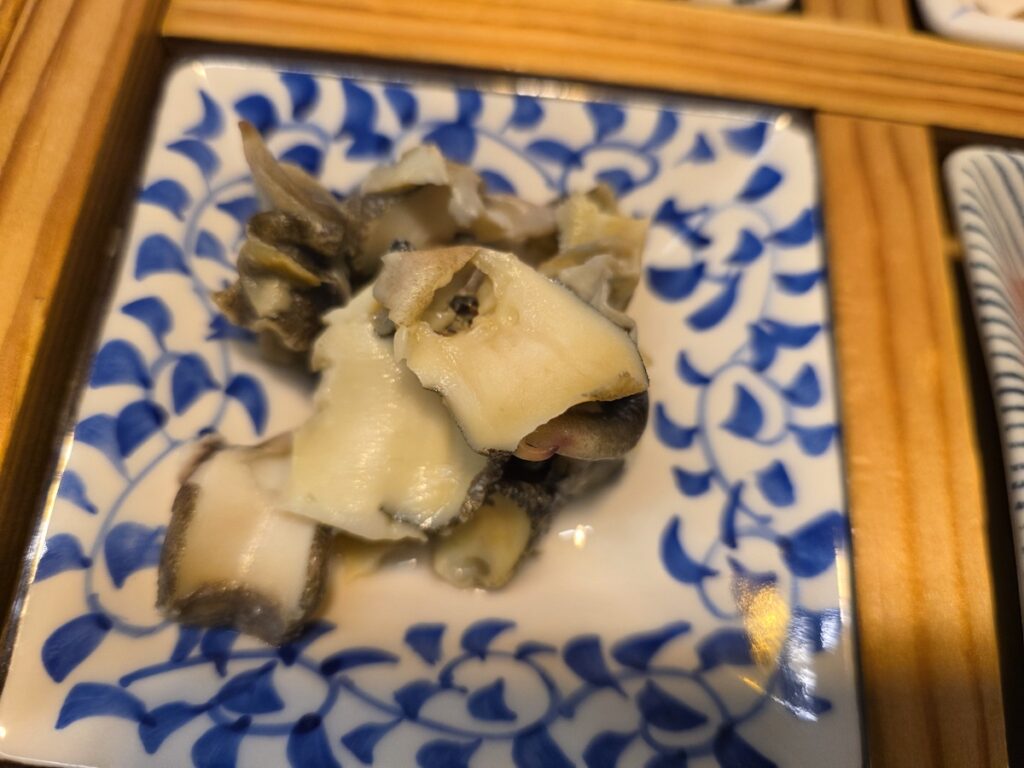 Several boiled conch (Sora) shells, providing essential minerals and a satisfying chewy texture without the added calories or oils of meat at a Korean sashimi restaurant.