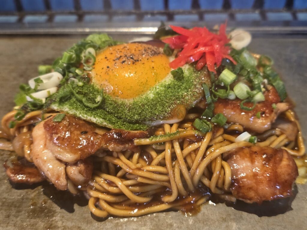 what to eat in Hongdae showing Japanese style noodles with egg and grilled meat at a local restaurant in Seoul